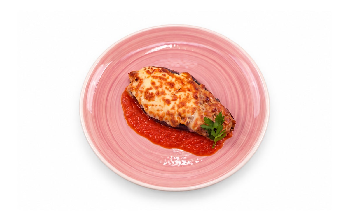 Berenjena rellena gratinada con mozzarella · Cocinatur. Fotografía retocada con IA para adaptar fondo y encuadre